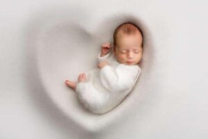 A newborn baby sleeps peacefully